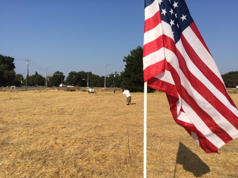 John Vinson and Jerry Shockley begin measuring plot points for thousands of American flags that are part of an annual 9/11 memorial.