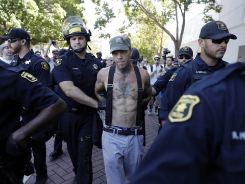A demonstrator is arrested during a free speech rally Sunday, Aug. 27, 2017, in Berkeley, Calif. 