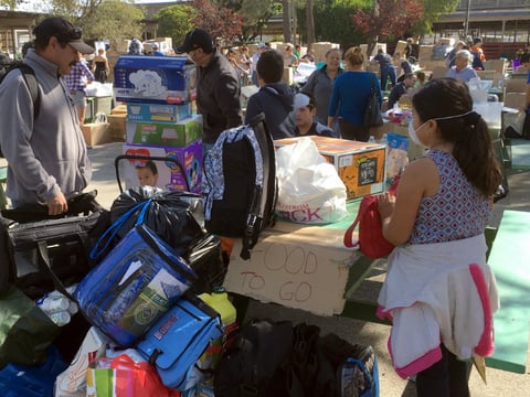Wildfire evacuee Francisco Macias, a landscape worker from Santa Rosa, Calif., collects donated blankets, baby diapers and food supplies for his family at the Sonoma-Marin Fairgrounds in Petaluma, Calif., Sunday, Oct. 15, 2017.