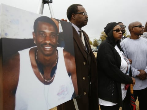 FILE - In this Oct. 3, 2016 file photo, a picture of Joseph Mann, who was killed by Sacramento Police last July, is displayed at a news conference held by his sister, Deborah, center, and brother, Robert Mann, right, in Sacramento, Calif. 
