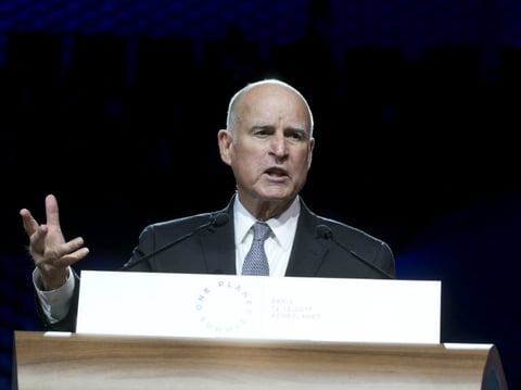 California Gov. Jerry Brown speaks to delegates as part of a session of the One Planet Summit, in Boulogne-Billancourt near Paris, France, Tuesday, Dec. 12, 2017. 