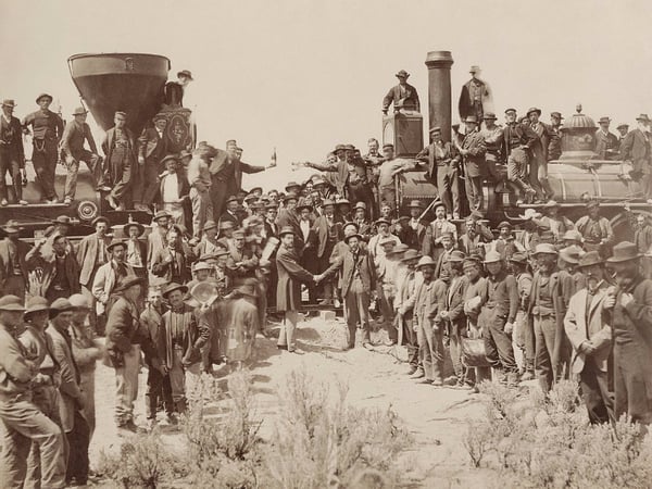 The ceremony for the driving of the golden spike at Promontory Summit, Utah on May 10, 1869; completion of the First Transcontinental Railroad. 