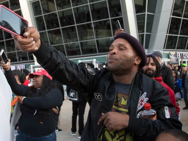 Demonstrators point cell phones at police outside the Golden 1 Center, a reference to Stephon Clark having only a cell phone when he was shot by police.