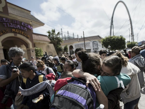 Central Americans who travel with a caravan of migrants embrace in Tijuana, Mexico, before crossing the border and request asylum in the United States, Sunday, April 29, 2018. 