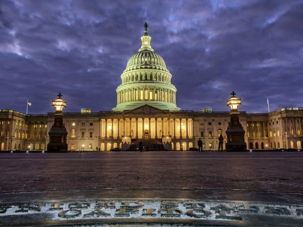In this Jan. 21, 2018, file photo, lights shine inside the U.S. Capitol Building as night falls in Washington.