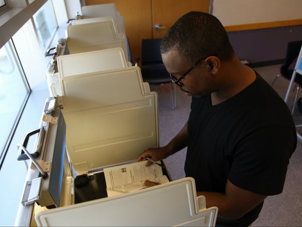 Lorenzo Island votes in person at North Natomas Library.