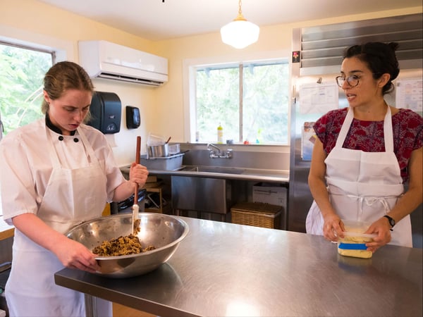 Meristem student Mackenzie Foy, prepares chocolate chip cookies under the instruction of Lucy Plumb-Reyes.