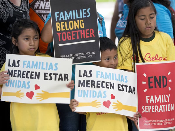 In this June 1, 2018, file photo, children hold signs during a demonstration against the Trump administration's family separation policy in front of the Immigration and Customs Enforcement offices in Miramar, Fla. 