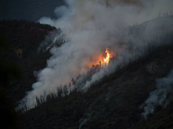 Flames from the Ferguson Fire burn down a hillside in unincorporated Mariposa County Calif., near Yosemite National Park on Sunday, July 15, 2018. 