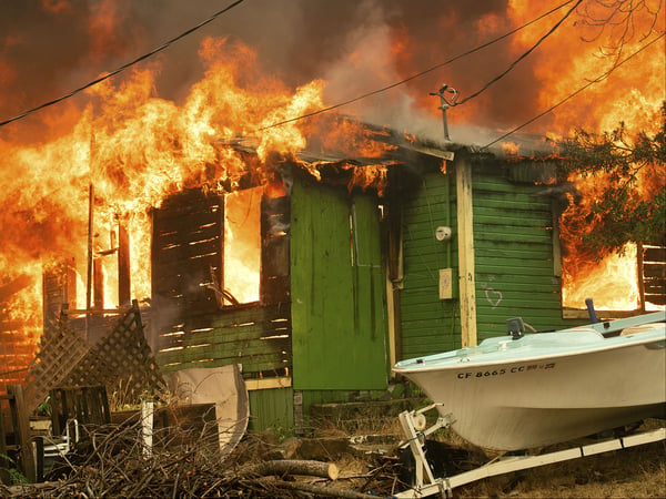 A residence burns as the Carr Fire tears through Shasta, Calif., on Thursday, July 26, 2018.