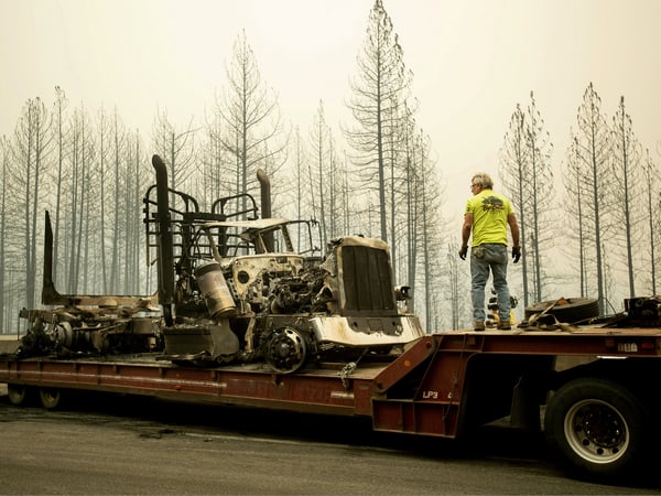 Bruce Palmer prepares to tow a truck scorched by the Delta Fire on Interstate 5 in the Shasta-Trinity National Forest near Shasta Lake on Thursday, Sept. 6, 2018.