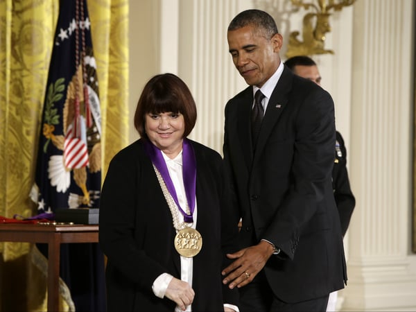 President Obama helps singer Linda Ronstadt off stage in the East Room of the White House in Washington, July 28, 2014, during a ceremony where he presented her with a 2013 National Medal of Arts.