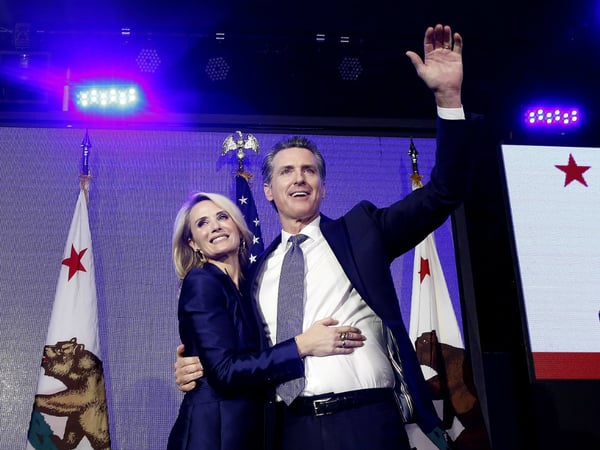 Lt. Gov Gavin Newsom, a Democrat, hugs his wife,Jennifer Siebel Newsom as he celebrates at an election night party after he defeated Republican opponent John Cox to become 40th governor of California Tuesday, Nov. 6, 2018, in Los Angeles, Calif.