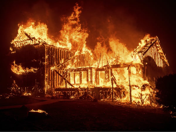 A home burns as the Camp Fire rages through Paradise, Calif., on Thursday, Nov. 8, 2018.