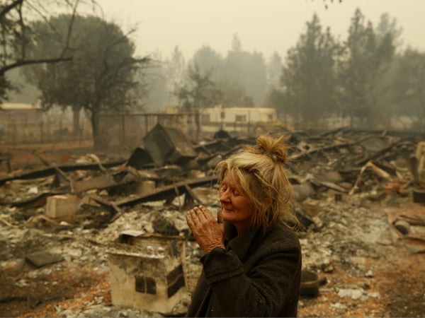 Cathy Fallon reacts as she stands near the charred remains of her home, Friday, Nov. 9, 2018, in Paradise, Calif. "I'll be darned if I'm going to let those horses burn in the fire," said Fallon.