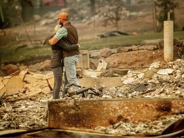 Chris and Nancy Brown embrace while searching through the remains of their home, leveled by the Camp Fire, in Paradise, Calif., on Monday, Nov. 12, 2018. As the fire approached, Nancy Brown escaped from the home with her 2-year-old and three dogs.