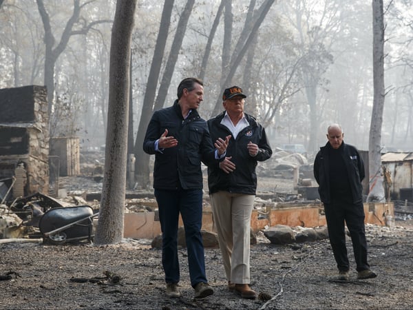 President Donald Trump talks with then California Gov.-elect Gavin Newsom during a visit to a neighborhood destroyed by the wildfires, Saturday, Nov. 17, 2018, in Paradise, Calif. At right is former California Gov. Jerry Brown.