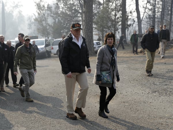 President Donald Trump walks with Mayor Jody Jones as he visits a neighborhood impacted by the wildfires, Saturday, Nov. 17, 2018, in Paradise, Calif.