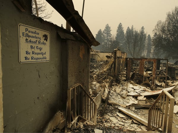 A sign hangs on a wall at the Paradise Elementary School destroyed by the Camp Fire, Tuesday, Nov. 13, 2018, in Paradise, Calif.