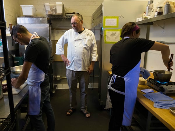 Chef Patrick Mulvaney (center) checks on Catering Chef Jared Serviss (left) and Pastry Chef Katlyn Beggs (right) at Mulavaney's Midtown restaurant in 2018.