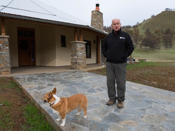 Gov. Jerry Brown stands with his dog in front of his house on his family's land near Williams in Colusa County.