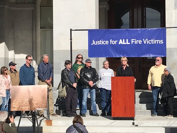 Consumer advocate Erin Brockovich, who famously took on Pacific Gas & Electric Co. in the 1990s, stands with wildfire victims and speaks outside the state Capitol Tuesday, Jan. 22, 2019, in Sacramento.