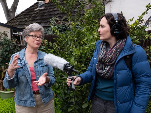 Question asker Ellen Chapman and reporter Julia Mitric talk about green waste in Chapman's yard.