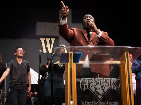 Dr. Tecoy Porter leads prayer at Genesis Church in Sacramento.