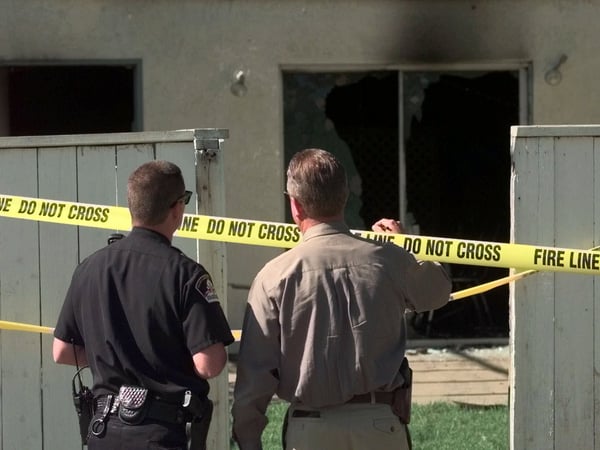Investigators look over damage to the Kenesset Israel Torah Center in Sacramento, Calif., Friday, June 18, 1999, after a suspected arson fire. The temple was one of three targeted in arson fires during the night.