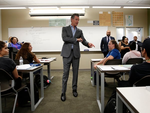 In this Aug. 27, 2019 file photo Gov. Gavin Newsom talks with students during his visit to a political science class at Cosumnes River College in Sacramento, Calif.