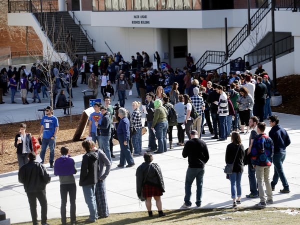 In this Feb. 20, 2016 file photo people line up to participate in the Democratic caucus at the University of Nevada in Reno, Nev.