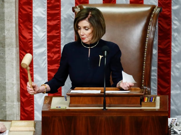 House Speaker Nancy Pelosi of Calif., strikes the gavel after announcing the passage of article II of impeachment against President Donald Trump, Wednesday, Dec. 18, 2019, on Capitol Hill in Washington.