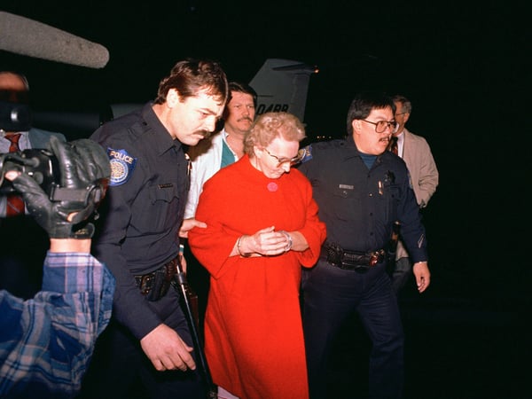 Dorothea Montalvo Puente, center, is escorted by Sacramento police at the airport early Thursday morning, Nov. 17, 1988 as she was brought to Sacramento from Los Angeles by a chartered jet.