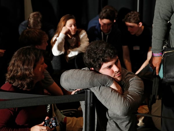 People wait for results at a caucus night campaign rally for democratic presidential candidate former Vice President Joe Biden on Monday, Feb. 3, 2020, in Des Moines, Iowa.