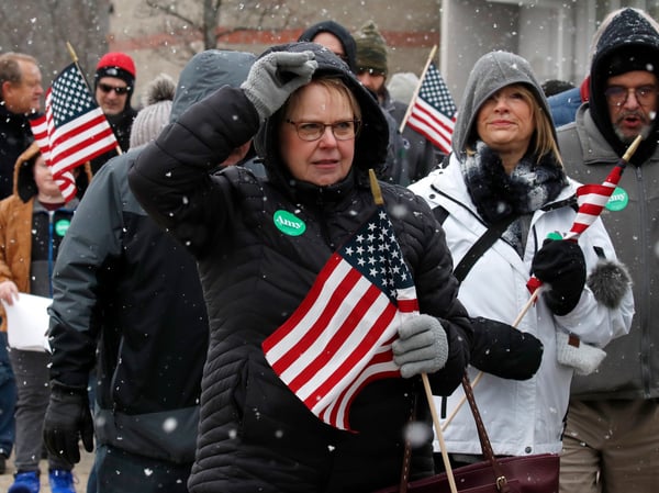 People wait on line in the snow to see Democratic presidential candidate Sen. Amy Klobuchar, D-Minn., at a campaign event, Sunday, Feb. 9, 2020, in Nashua, N.H.