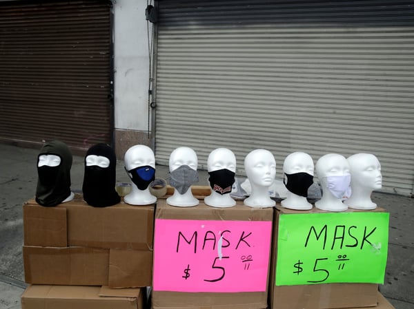 Masks are sold on a street corner Sunday, April 5, 2020, amid the coronavirus pandemic in Los Angeles.