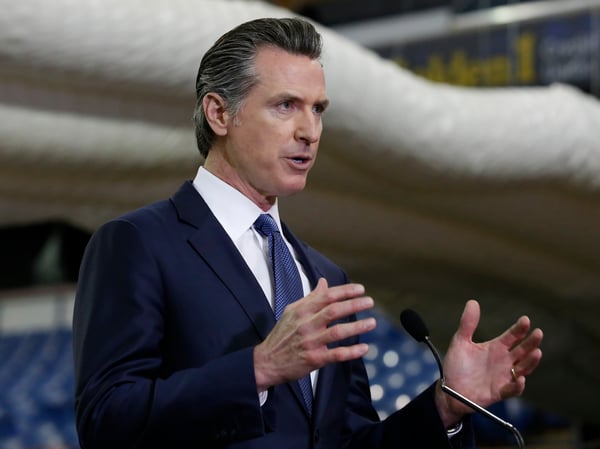 In this Monday April 6, 2020 file photo, Gov. Gavin Newsom discusses the acquisition of the Sleep Train Arena for use as a field hospital, after touring the facility, in Sacramento, Calif.