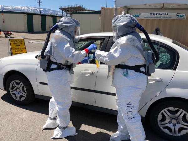 Washoe County Health District employees demonstrate how they collect samples at a drive through testing site in Reno, on Monday, April 13, 2020.