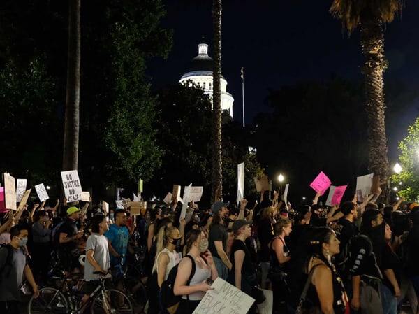 Demonstrators march down L Street in downtown Sacramento on June 3, 2020 to protest the killing of George Floyd by Minneapolis police.
