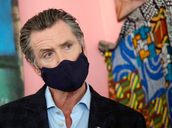 Gov. Gavin Newsom wears a protective mask on his face while speaking to reporters at Miss Ollie's restaurant during the coronavirus outbreak in Oakland, Calif., Tuesday, June 9, 2020.