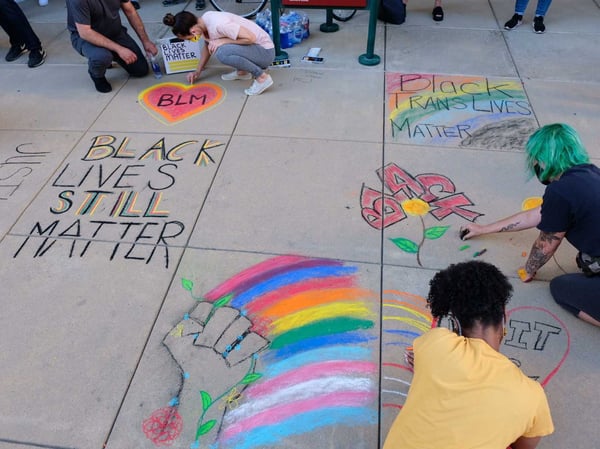 Crowds draw Black Lives Matter messages in chalk outside of Sacramento City Hall.