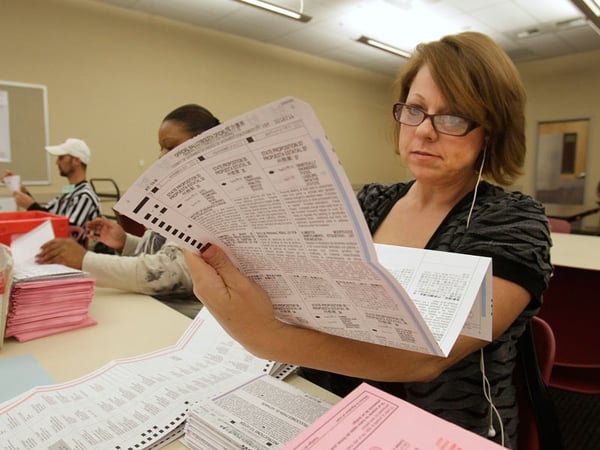 Victoria Williams processes a mail-in ballot at the Sacramento County Registrar of Voters office in Sacramento, Calif., Wednesday, Oct. 31, 2012. 