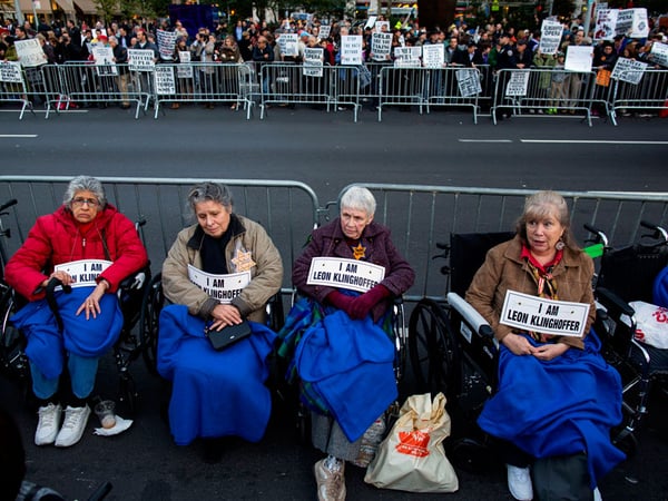 People, some in wheelchairs, gather at Lincoln Center as they protest "Death of Klinghoffer" Monday, Oct. 20, 2014, in New York. American composer John Adams' opera has been a lightning rod since February, when it was first scheduled for this season.