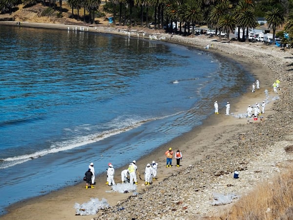 Crews from Patriot Environmental Services collect oil-covered seaweed and sand from the shoreline at Refugio State Beach, north of Goleta, Calif., Wednesday, May 20, 2015. 