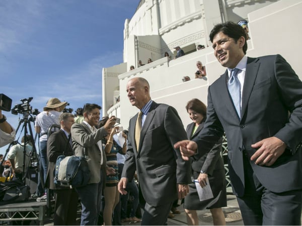 California Gov. Jerry Brown, center, arrives with Senate President pro Tempore Kevin De Leon, D-Los Angeles, right, and Assembly speaker Toni Atkins, second from right, to sign landmark legislation SB 350 to combat climate change.