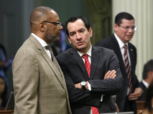 In this photo taken Wednesday Sept. 2, 2015, Assemblyman Reginald Jones-Sawyer, Sr, D-Los Angeles, left, talks with Assembly Anthony Rendon, D-Lakewood, at the Capitol in Sacramento,Calif. 