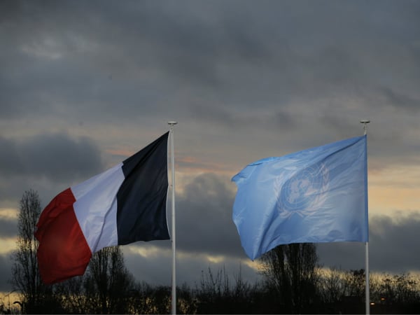 The flags of the U.N. and France fly as world leaders arrive for the COP21, United Nations Climate Change Conference, in Le Bourget, outside Paris, Monday, Nov. 30, 2015.