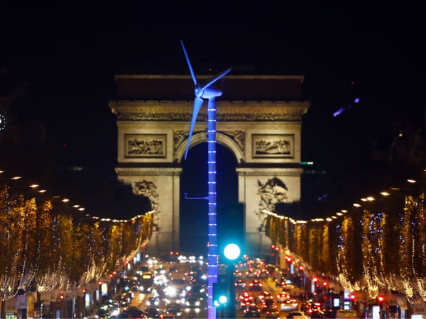 A power-generating windmill turbine is seen on the Champs Elysees avenue with the Arc de Triomphe in background as part of the COP21, United Nations Climate Change Conference, in Paris, Wednesday, Dec. 2, 2015.
