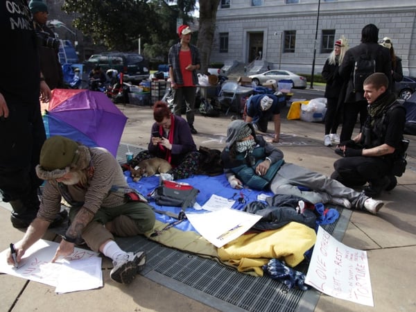 Protesters and homeless people make signs outside Sacramento City Hall in their attempt to get the city to repeal a no-camping ordinance.