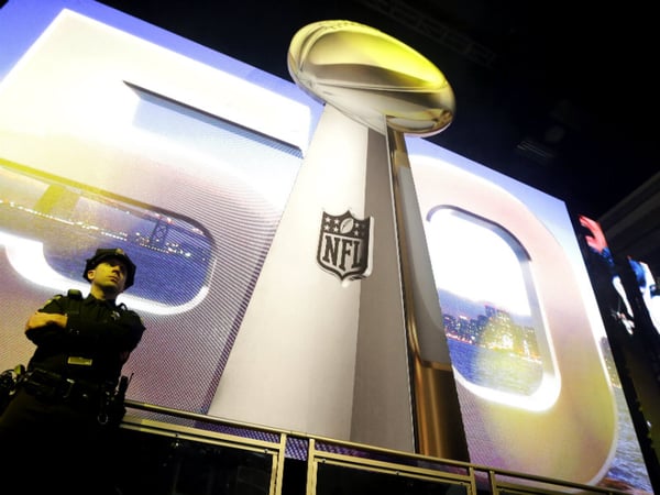 San Francisco Police officer M. Ryan keeps watch at the Vince Lombardi Trophy display inside the NFL Experience Tuesday, Feb. 2, 2016, in San Francisco. The Denver Broncos will play the Carolina Panthers in Super Bowl 50 Sunday, Feb. 7, 2016. 